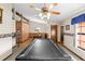 Spacious game room with a pool table, hardwood floors, and a ceiling fan with integrated lighting at 4289 Castle Ave, Spring Hill, FL 34609