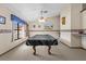 Cozy game room with a covered pool table, natural light, and neutral carpet at 4289 Castle Ave, Spring Hill, FL 34609