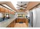 Bright kitchen with wood cabinets, stainless steel appliances, and a large island counter with seating at 4289 Castle Ave, Spring Hill, FL 34609