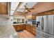 Well-lit kitchen with stainless steel appliances, wood cabinetry, and a light-filled space at 4289 Castle Ave, Spring Hill, FL 34609
