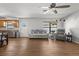 Bright living room featuring hardwood floors, modern furniture, and stainless steel kitchen appliances at 4289 Castle Ave, Spring Hill, FL 34609