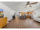 Spacious living room with hardwood floors flowing into a dining area and stainless steel appliances at 4289 Castle Ave, Spring Hill, FL 34609