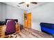 Bright office with wood flooring, gray walls, ceiling fan, and an orange door to another room at 4289 Castle Ave, Spring Hill, FL 34609