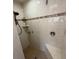 Shower featuring tile walls and floor, with seat and updated showerhead at 4289 Castle Ave, Spring Hill, FL 34609