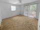Bright bedroom featuring a ceiling fan and sliding glass doors at 4388 Craftsbury Dr, New Port Richey, FL 34652