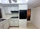 Updated kitchen with modern black appliances and white cabinets near door to outside at 4388 Craftsbury Dr, New Port Richey, FL 34652