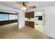 Cozy kitchen area with wood accents and an adjoining room with a ceiling fan at 4388 Craftsbury Dr, New Port Richey, FL 34652