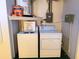 Laundry room setup with washer, dryer, and storage shelf at 4388 Craftsbury Dr, New Port Richey, FL 34652