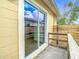 Back porch with sliding glass door and wooden railing at 4503 Courtland St, Tampa, FL 33610