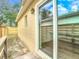 Exterior view of back porch showing glass sliding door and wooden railing at 4503 Courtland St, Tampa, FL 33610