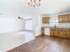 Open-concept kitchen with wood cabinets and white appliances seamlessly connected to a bright living area at 4503 Courtland St, Tampa, FL 33610