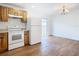 Modern kitchen with wood cabinets, white appliances, and a sliding glass door to the backyard at 4503 Courtland St, Tampa, FL 33610