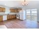 Modern kitchen with wood cabinets and white appliances seamlessly connected to a bright living area at 4503 Courtland St, Tampa, FL 33610