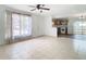 Bright living room with tile flooring, ceiling fan, and view into the kitchen at 4503 Courtland St, Tampa, FL 33610
