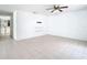 Open living room featuring tiled floors, ceiling fan and small shelves at 4503 Courtland St, Tampa, FL 33610