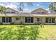 This stunning backyard includes a manicured lawn and building with screened-in back porch at 4557 Glen Holw, New Port Richey, FL 34653