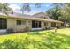 This beautiful backyard includes a manicured lawn and building with screened-in back porch at 4557 Glen Holw, New Port Richey, FL 34653