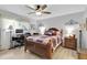 Cozy bedroom featuring wood-look flooring, a ceiling fan, and a serene atmosphere for relaxation and rest at 4557 Glen Holw, New Port Richey, FL 34653