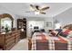 Cozy bedroom featuring wood-look flooring, a ceiling fan, and a serene atmosphere for relaxation and rest at 4557 Glen Holw, New Port Richey, FL 34653
