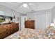 This cozy bedroom has wood furnishings, a ceiling fan, and a TV for relaxing comfortably at 4557 Glen Holw, New Port Richey, FL 34653