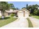 Charming home featuring attached two-car garage and well-maintained lawn and manicured shrubbery at 4557 Glen Holw, New Port Richey, FL 34653
