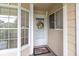 Front door with decorative wreath, sidelight window, and welcome mat at 4557 Glen Holw, New Port Richey, FL 34653