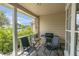 Relaxing covered patio with two chairs, small table, grill, and view of the outdoors at 4557 Glen Holw, New Port Richey, FL 34653