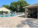 Community pool with lounge chairs surrounded by a well-maintained deck and greenery at 4557 Glen Holw, New Port Richey, FL 34653