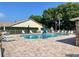 Inviting community pool with lounge chairs and mature trees providing a relaxing atmosphere at 4557 Glen Holw, New Port Richey, FL 34653