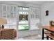 Bright sunroom with large windows and casual furnishings at 4557 Glen Holw, New Port Richey, FL 34653
