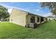 Well-maintained backyard with a lush lawn and a home exterior featuring a screened lanai at 4841 Wakefield Ct # 4841, New Port Richey, FL 34655