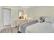Cozy bedroom features ample natural light, closet, neutral walls, and a decorative dresser with mirror at 4841 Wakefield Ct # 4841, New Port Richey, FL 34655