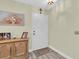 Inviting entryway featuring a neutral front door, wood-look flooring, and decorative accents at 4841 Wakefield Ct # 4841, New Port Richey, FL 34655