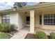 Welcoming front porch with brick flooring, and a lovely landscaped garden area at 4841 Wakefield Ct # 4841, New Port Richey, FL 34655