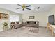 Comfortable living room featuring neutral decor, wood-look flooring, and a view into the adjacent rooms at 4841 Wakefield Ct # 4841, New Port Richey, FL 34655