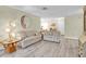 Inviting living room with a decorative mirror and neutral-toned walls leading to the dining area and front entrance at 4841 Wakefield Ct # 4841, New Port Richey, FL 34655
