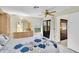 Bright bedroom with a king-sized bed, ceiling fan, and sliding glass door to the lanai at 4841 Wakefield Ct # 4841, New Port Richey, FL 34655