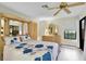 Bedroom with a large window, ceiling fan, and matching dresser with mirror at 4841 Wakefield Ct # 4841, New Port Richey, FL 34655