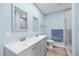 Modern bathroom features a double sink vanity with gray cabinetry and framed mirrors at 4939 Floramar Ter # 611, New Port Richey, FL 34652