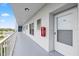 Hallway view showing the door to the unit and a building exterior railing at 4939 Floramar Ter # 611, New Port Richey, FL 34652