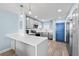 Updated kitchen with gray cabinets, stainless steel appliances, and breakfast bar, perfect for modern living at 4939 Floramar Ter # 611, New Port Richey, FL 34652