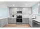 Bright kitchen features stainless steel appliances, updated cabinetry, and plentiful countertop space at 4939 Floramar Ter # 611, New Port Richey, FL 34652