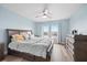 Bright and spacious main bedroom with a king bed, dresser, and serene blue color scheme at 4939 Floramar Ter # 611, New Port Richey, FL 34652
