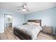A serene bedroom with a king-sized bed, two nightstands, and light blue walls at 4939 Floramar Ter # 611, New Port Richey, FL 34652