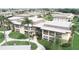 Aerial view of a multi-unit condo complex surrounded by lush green lawns and mature trees at 5123 Topaz Ln # 206, New Port Richey, FL 34652