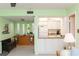 Open layout showing kitchen with white cabinetry, and view to adjacent room with buffet at 5123 Topaz Ln # 206, New Port Richey, FL 34652