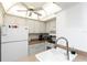 Efficient kitchen featuring white appliances, ample counter space, and classic design at 5123 Topaz Ln # 206, New Port Richey, FL 34652