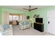 Bright living room featuring comfortable seating and a television at 5123 Topaz Ln # 206, New Port Richey, FL 34652