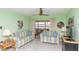 Comfortable living room with neutral furniture and seamless view into the light-filled sunroom at 5123 Topaz Ln # 206, New Port Richey, FL 34652