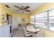 Bright sunroom featuring ample natural light, seating and a ceiling fan at 5123 Topaz Ln # 206, New Port Richey, FL 34652
